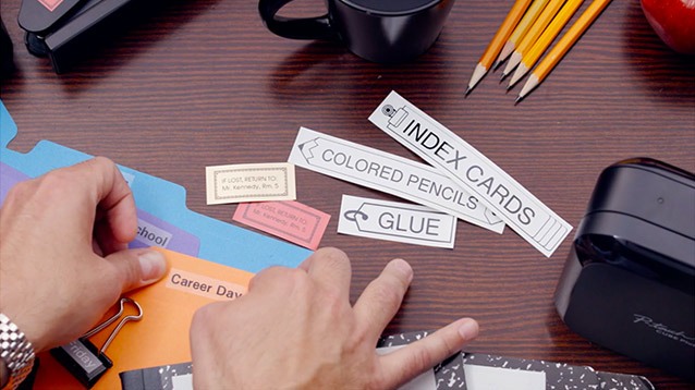 A hand model actor puts labels on a bunch of office folders in this corporate video production