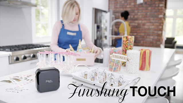 A female actress in her kitchen labeling party supplies for a video marketing production