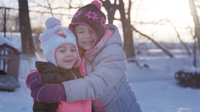 two children hug in the snow for a NJ Nonprofit Video Production
