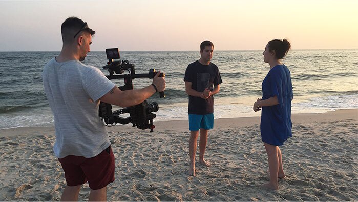 two actors on a beach are filmed for a NJ Video Marketing Agency commercial campign