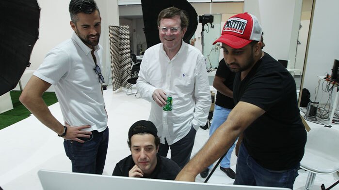 Client and crew look at a computer for a NJ Viral Video Production