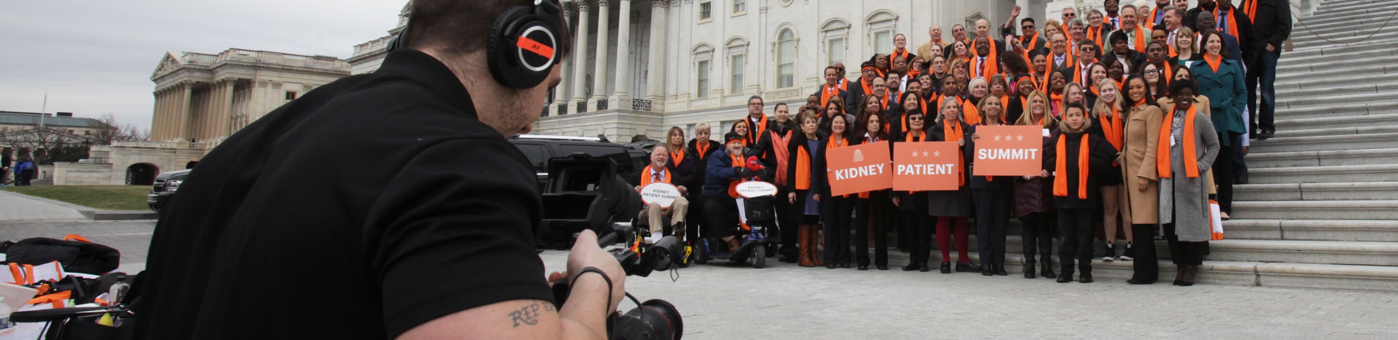 a group of supporters are filmed by an event videographer