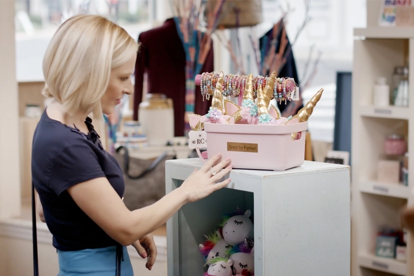a woman touches a product in a store for a NJ Commercial Video Production