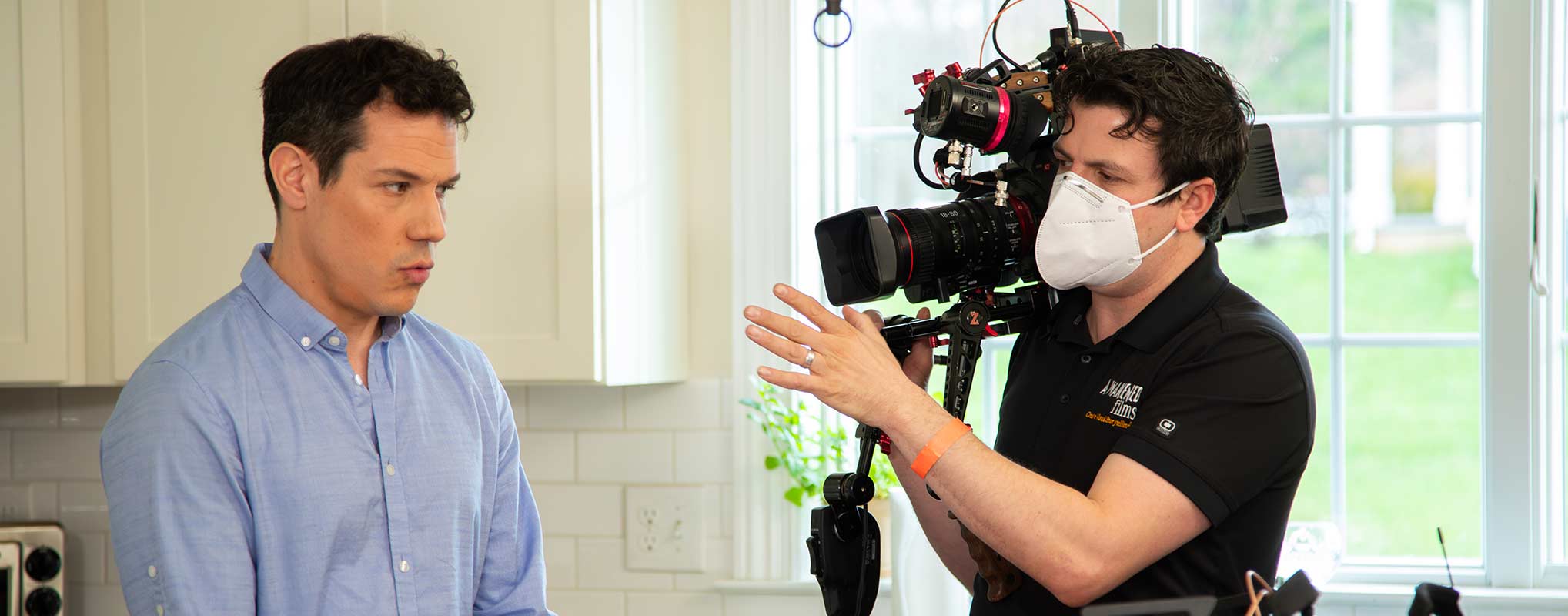 A Videorgapher helps direct talent in this Covid-era video production.