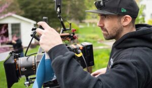 A Filmmaker checks settings before rolling camera
