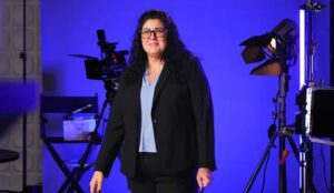A video marketing client, surrounded by film gear, is captured in our NJ video production studio