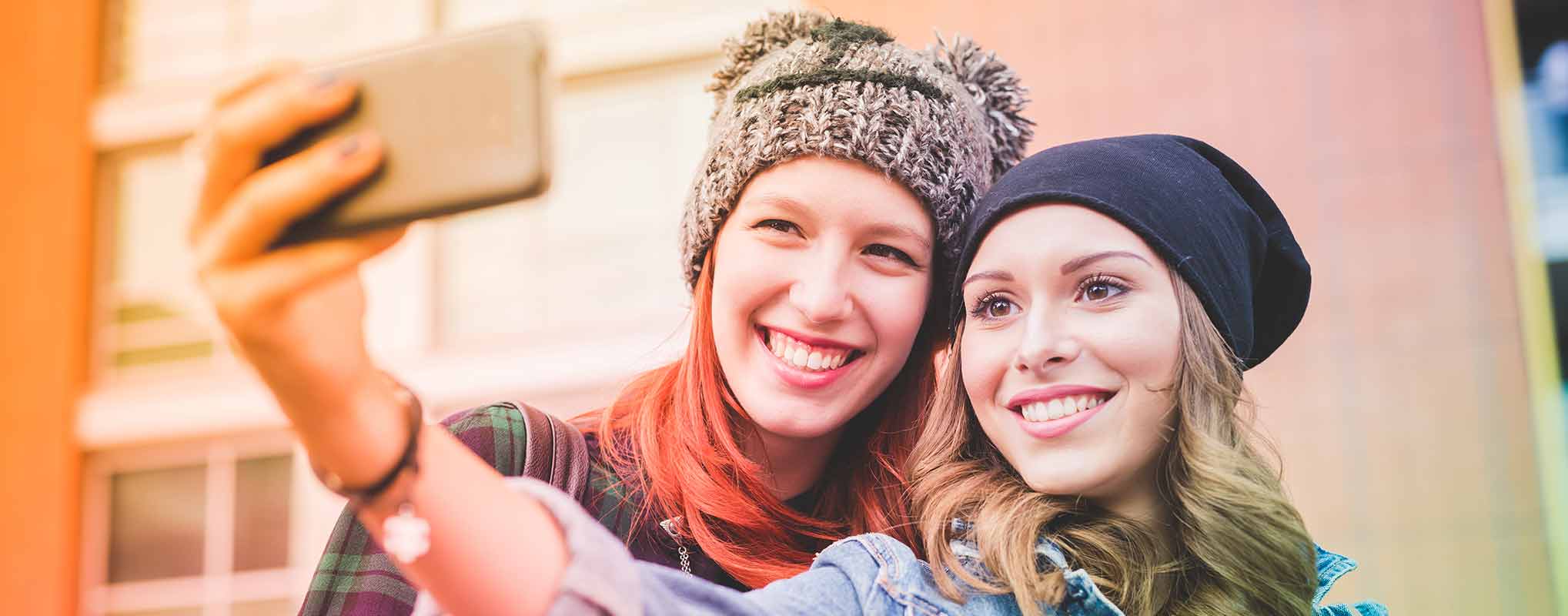 Two friends take a social media selfie