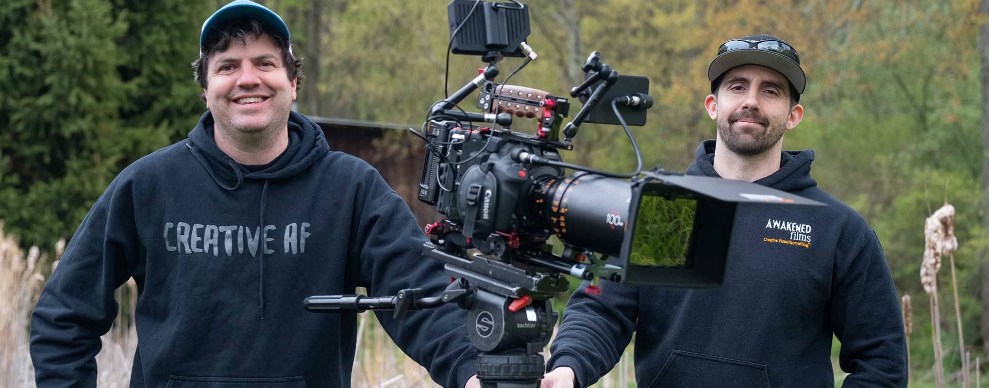 NJ creative production crew members pose with a large film camera