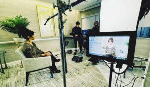 An actress appears on the monitor of an explainer production