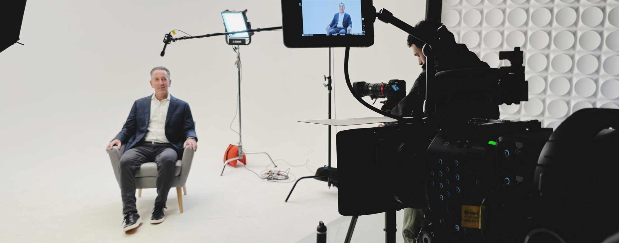 A man is filmed on a white background for Corporate Video Services in NJ studio