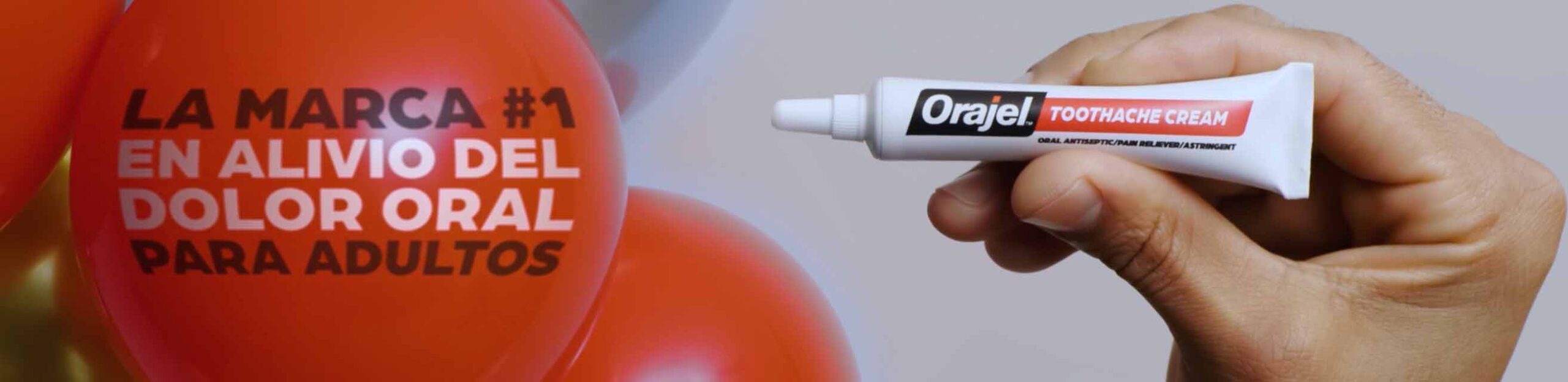 hand holding orajel bottle in orajel commercial video
