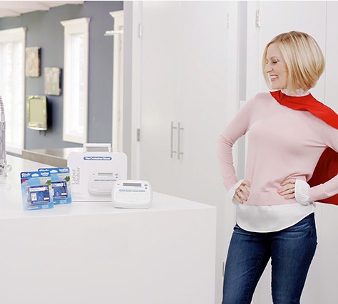 a young female actress with a cape posing next to a container store product is filmed for a NJ commercial