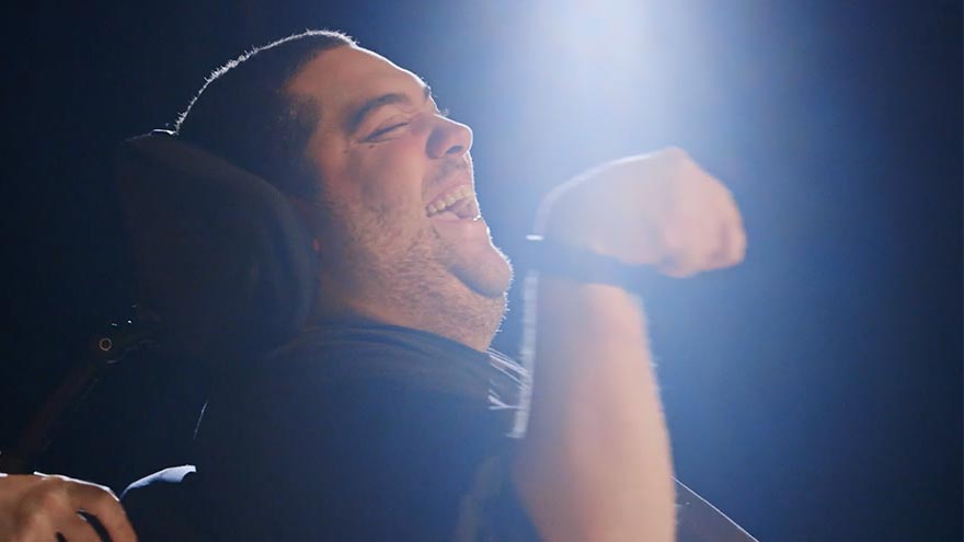 A man in a wheelchair smiles in a New Jersey Nonprofit Video Production Services - Arts Access Education Video