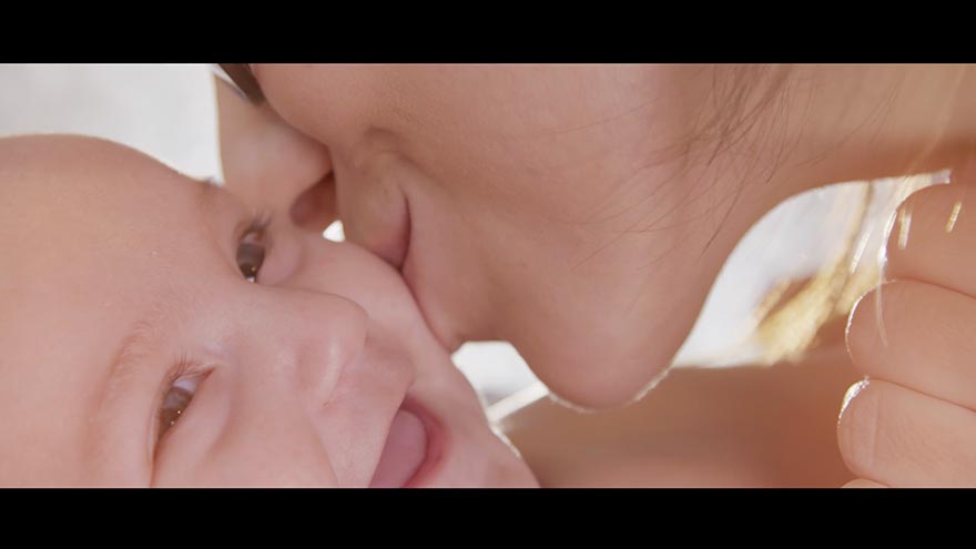 A mother kisses a baby in a New Jersey Narrative Film Production Services - ECLC of New Jersey