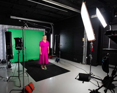 A female executive is filmed in front of a green screen for a NJ corporate video production