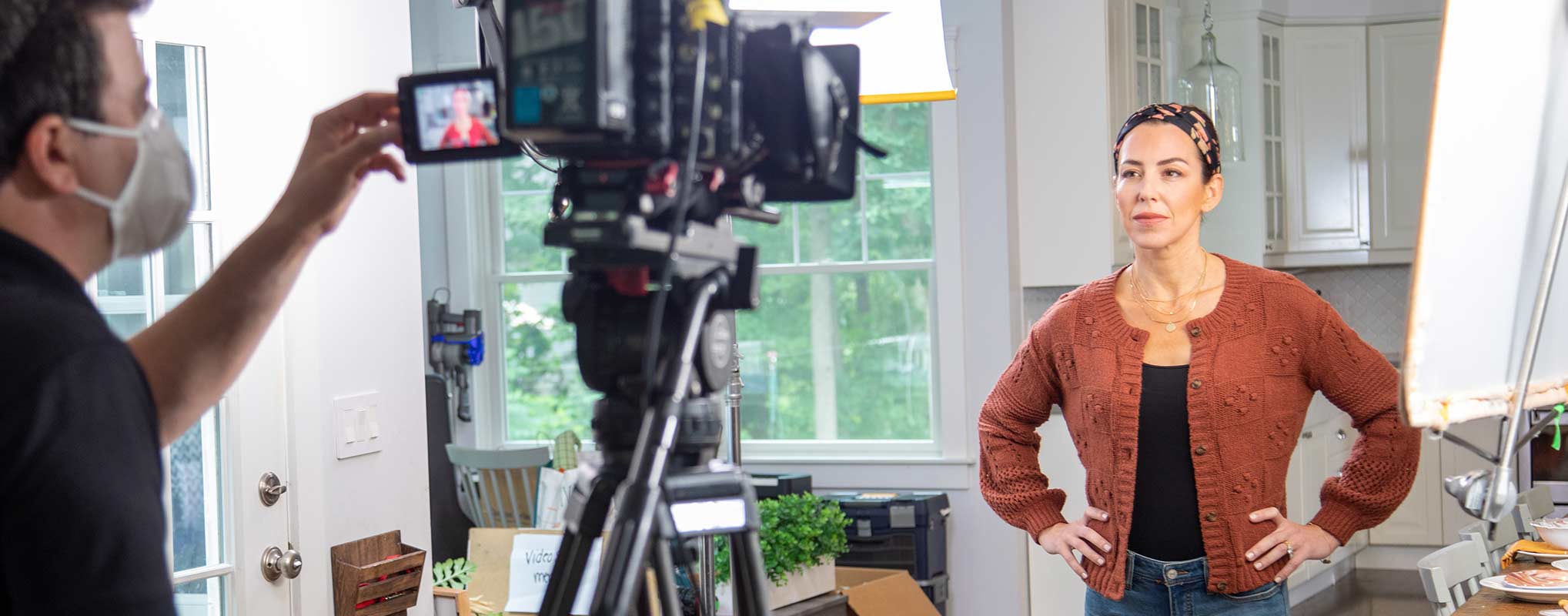A New Jersey commercial video production company frames up a shot of with a female actress in a kitchen