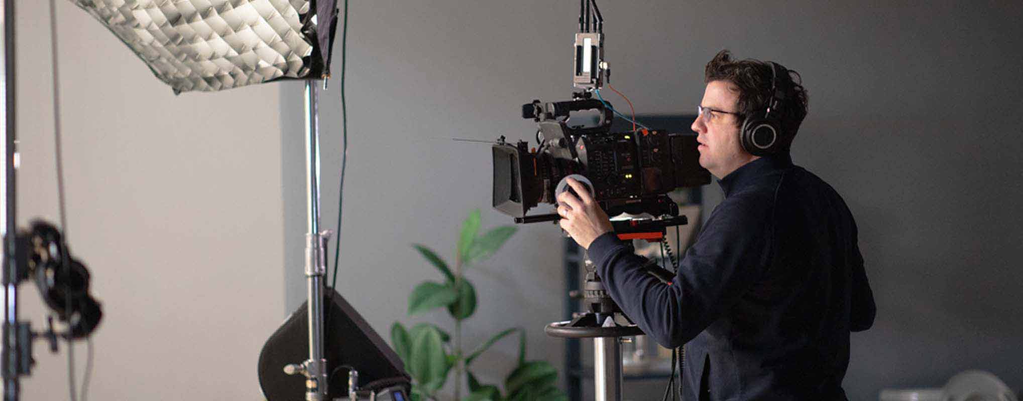 Camera man sets up shot during a video marketing production in 2025