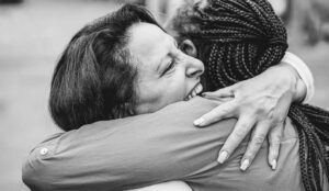 Two women in an emotional embrace.