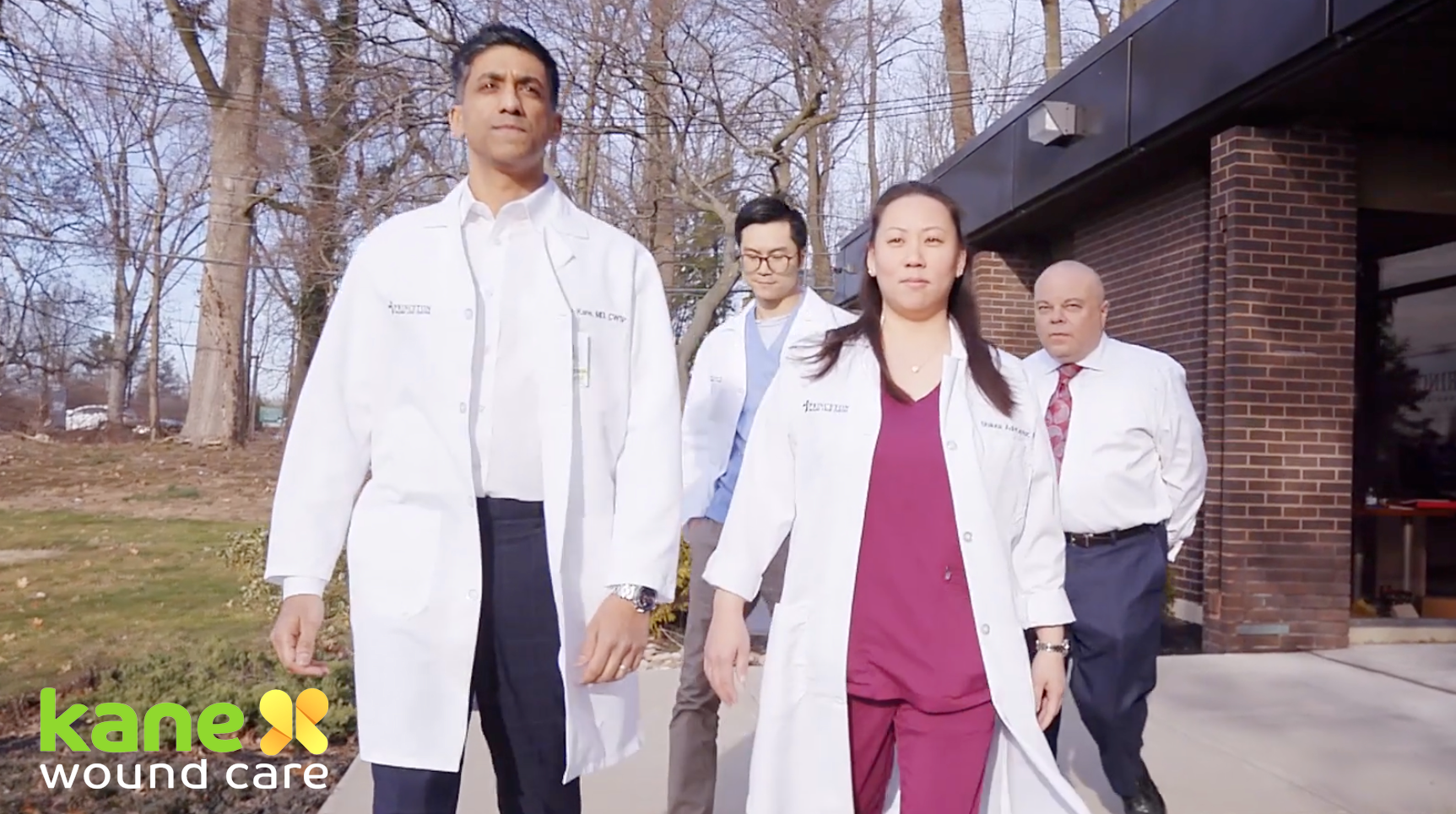 Doctors in lab coats walk towards the camera in a corporate video production