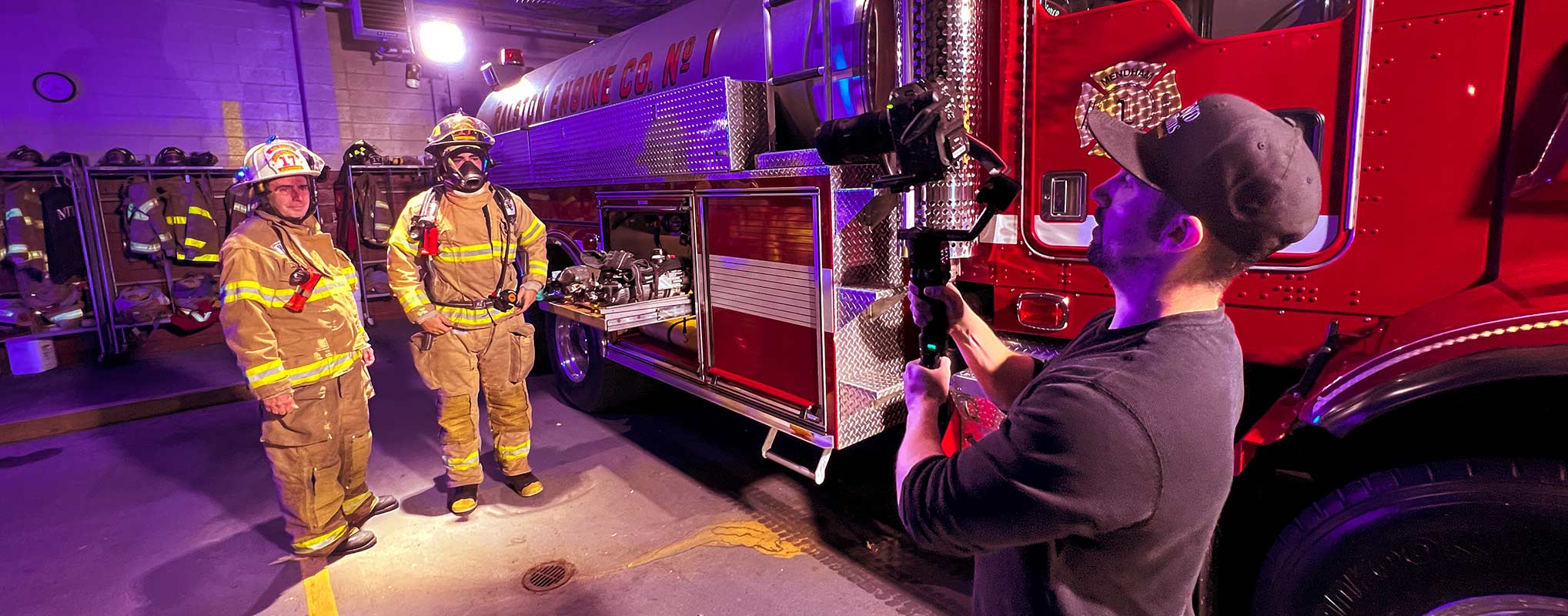A Filmmaker at Awakened Films uses a gimbal camera while filming a scene with firemen