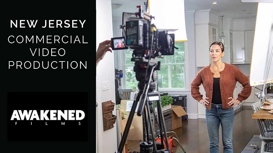 An actress stands in front of lights and camera while being filmed by a commercial video production company