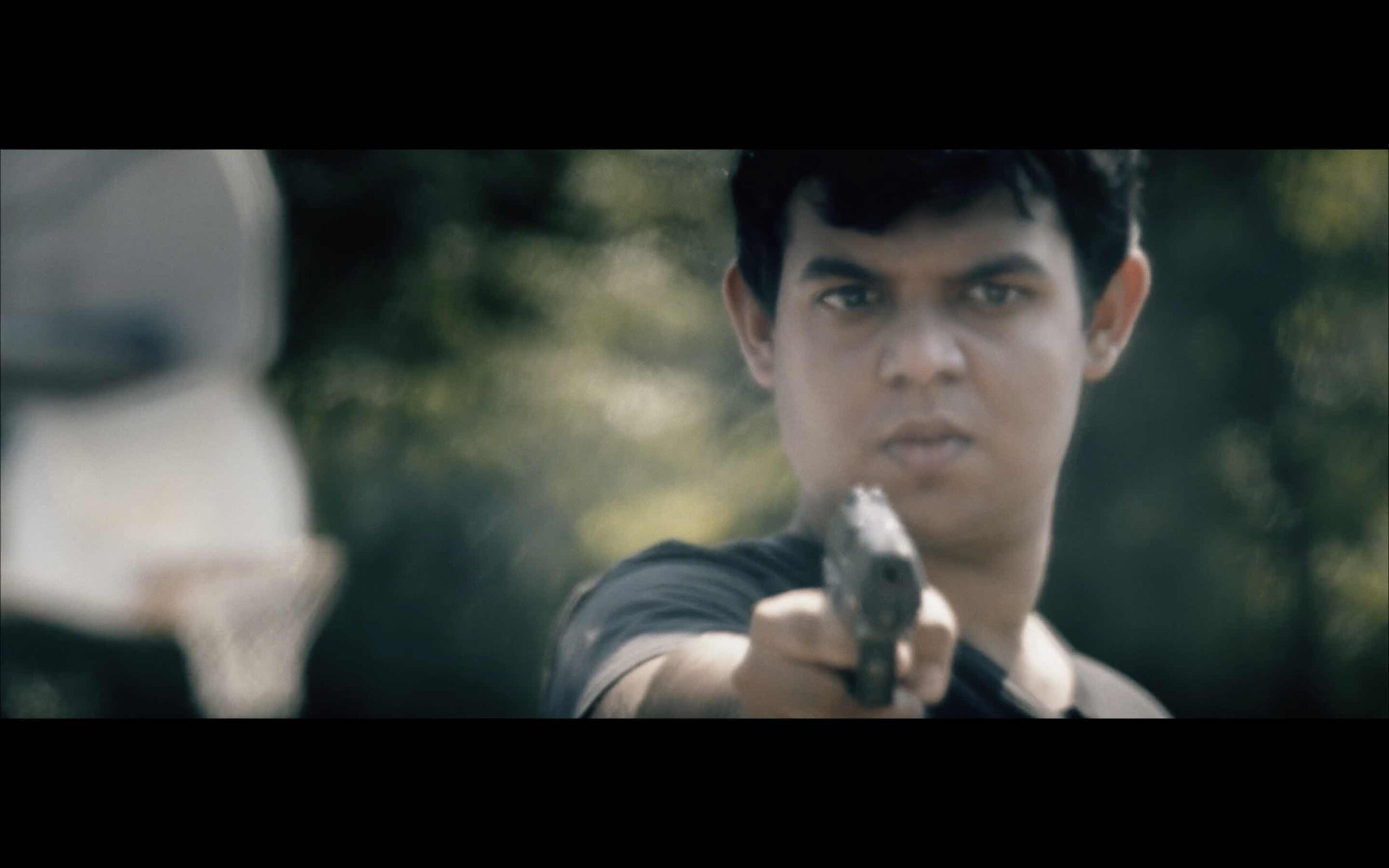 A young man holding a gun is filmed by a NJ filmmaking company