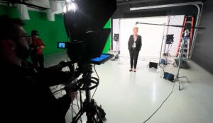 A woman is filmed with a teleprompter in a New Jersey Production Studio
