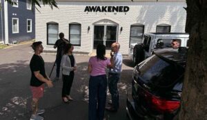 actors and crew gather outside of the studios at awakened films