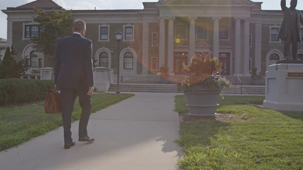 a lawyer walks up to the courthouse steps in a corporate video