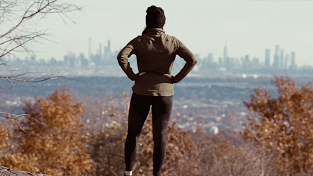 A woman standing on a mountain looks at the skyline in a Nature conservancy of New Jersey non-profit video production with awakened films