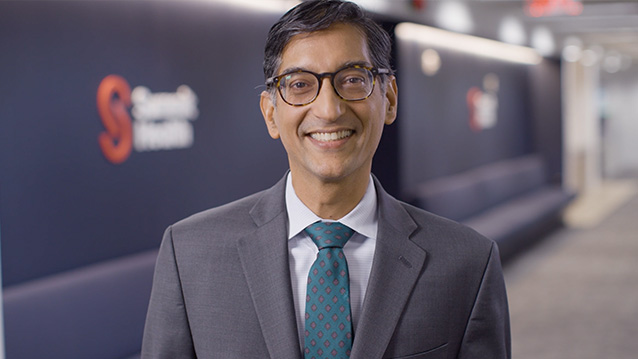 an hospital executive smiles for the camera in a medical video