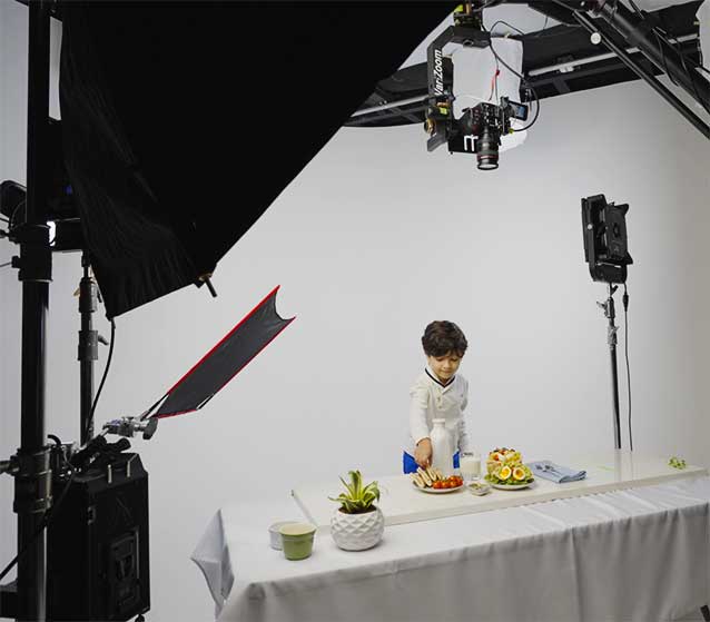 A young actor films a scene with pita bread in a new jersey commercial