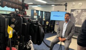 Camera man lines up the shot for a business man's interview in corporate video production