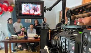 Camera filming group of people for video marketing project