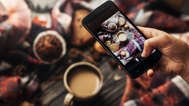 a person taking a picture of food for social media