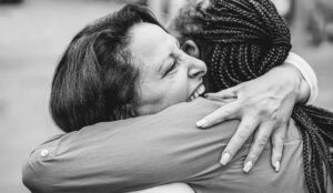 Two women in an emotional embrace.