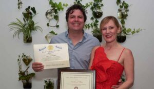local studio owners, jason and gillian schuler are presented a citation and commendation from the senator bucco