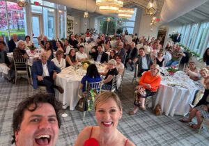 A group selfie from the awards stage with jason and gillian schuler