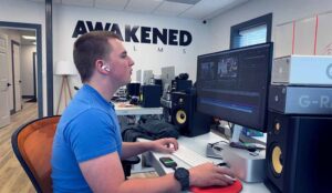 A young video company editor at Awakened Films works on a social media marketing series for a client