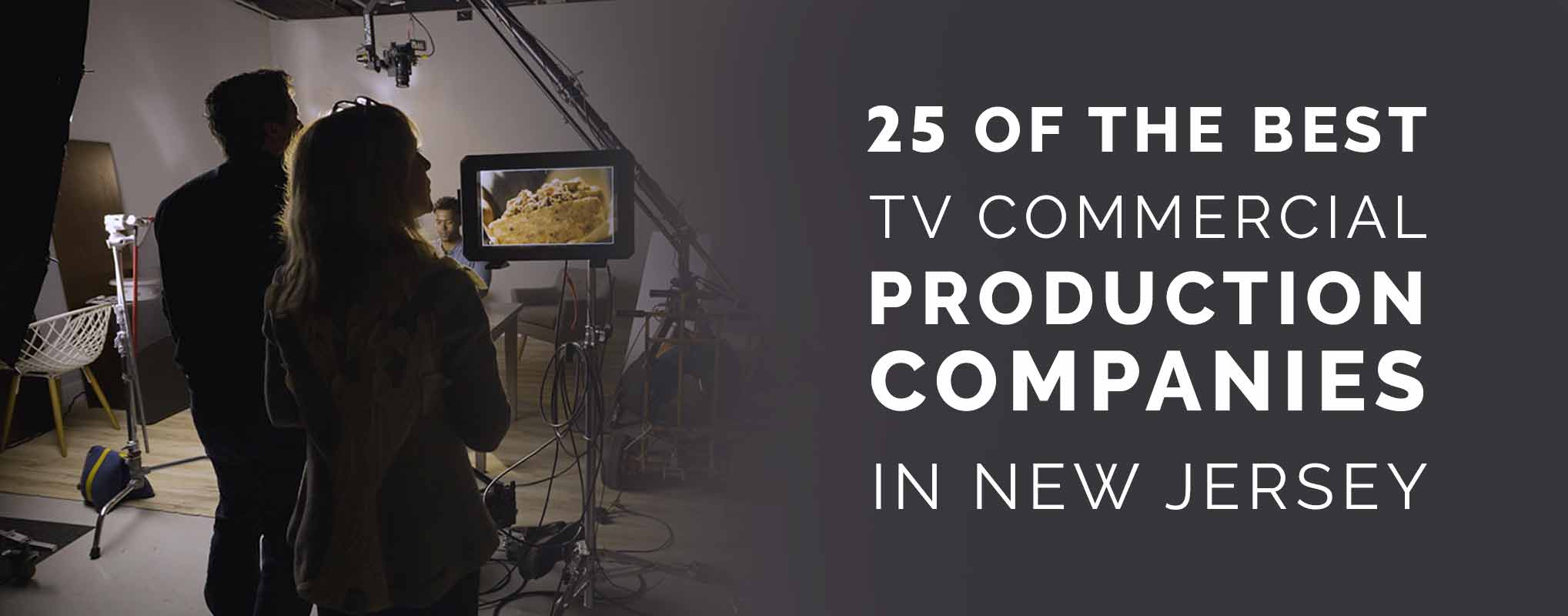 A male director and a female producer look at a monitor during a TV commercial production