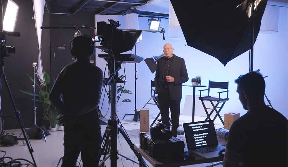 A movie producer is filmed at Awakened Films' NJ Production Studio