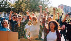 A group of protesters raise their fists in solidarity