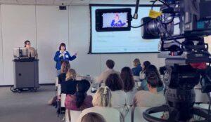 An event videography camera captures a corporate event.