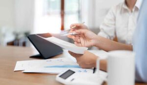A marketing team looks a video production cost documents in a corporate office